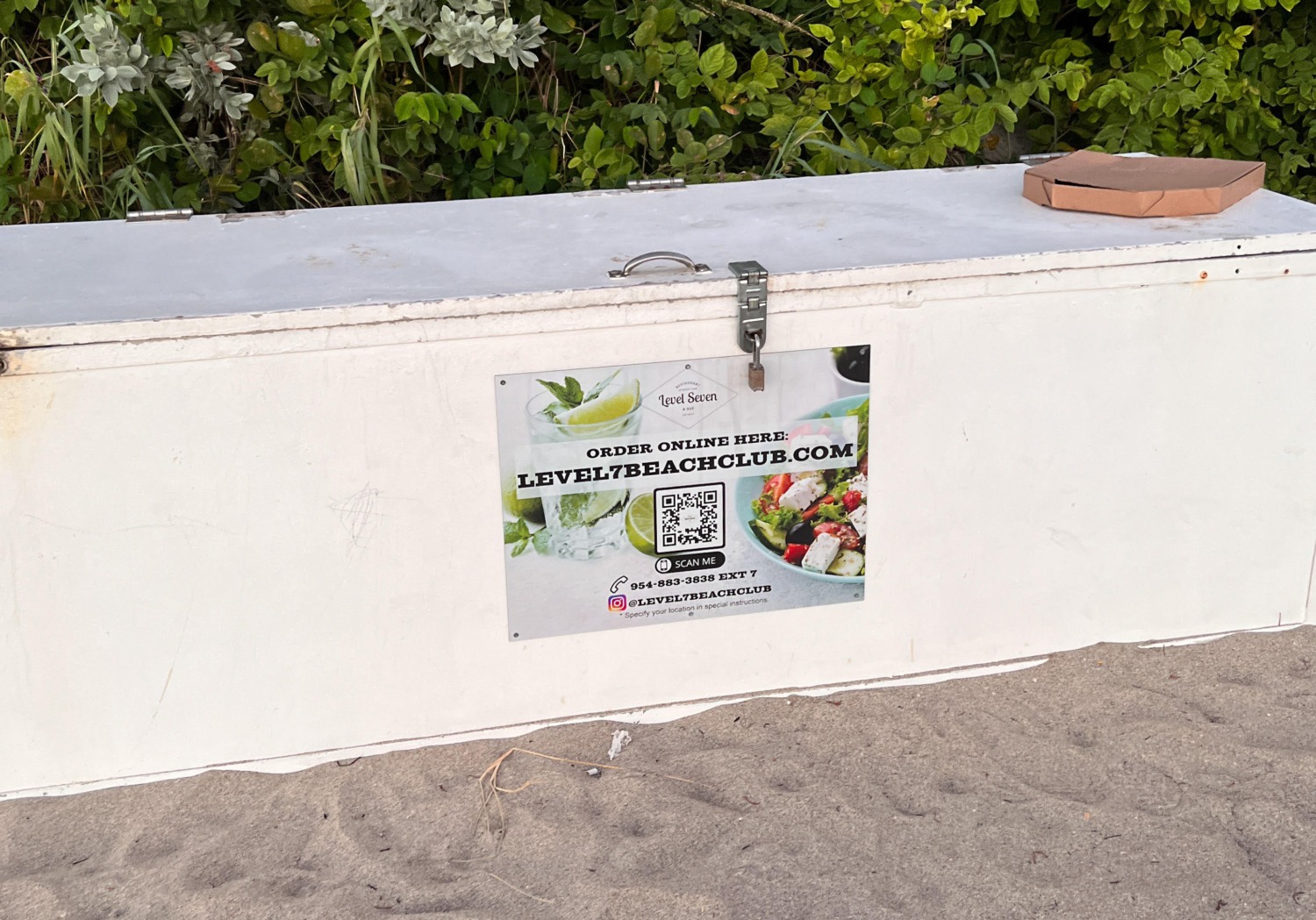 QR Code Sign on a Beach for a Restaurant on a bench